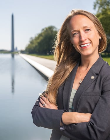 a woman in a suit and tie smiling
