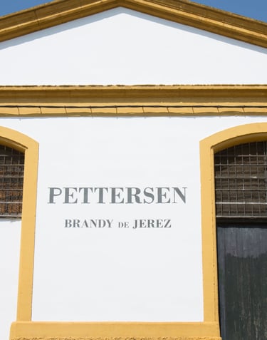 Depicting the grand main entrance of Pettersen Brandy's bodega located in Jerez de la Frontera.