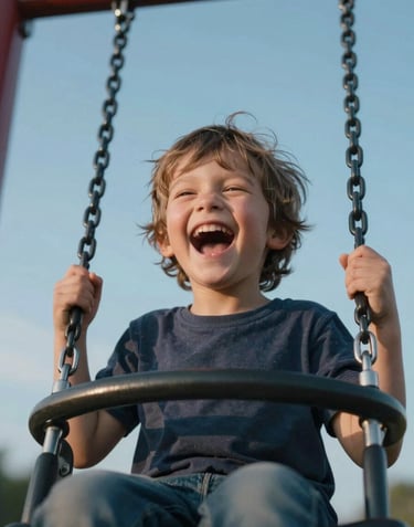 Close-up of a joyful, laughing child on a modern playground swing against a clear sky blue background, professional photography with soft focus, Southeast European.