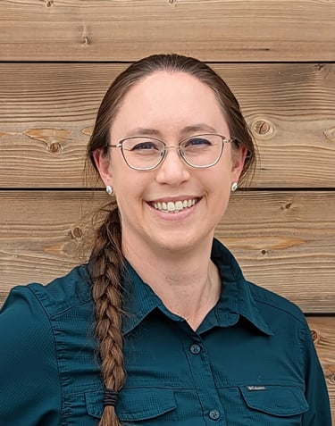 a woman with glasses and a blue shirt