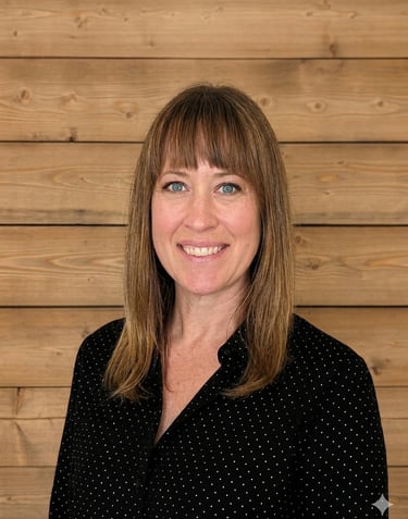 Professional headshot of a smiling woman with brown hair against a rustic wood plank background.