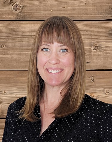 a woman with blue eyes and a black shirt