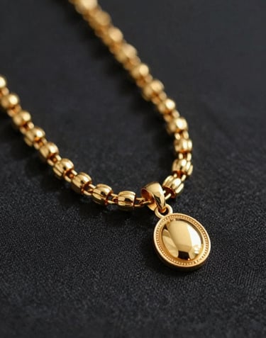 A premium close-up of gold Nigerian jewelry on a dark #3D2C20 textured fabric, representing the artist's cultural heritage and luxury aesthetic.