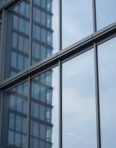 A modern architectural detail of a glass building reflecting a blue sky, representing innovation and vision. The shot is clean and high-contrast, featuring #415A77 and #E0E1DD highlights.