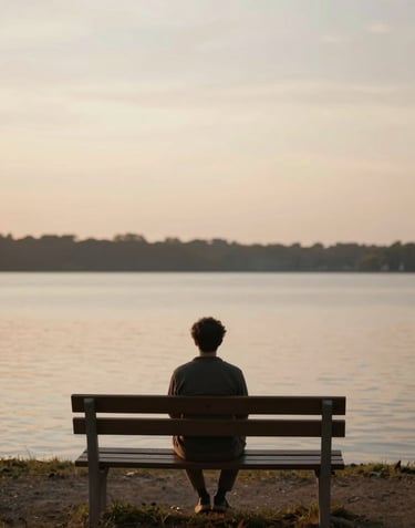A person sitting on a wooden bench overlooking a quiet lake at dusk, with deep brown #4A3D36 shadows and soft cream #F8F4EF sky. Peaceful and intimate.