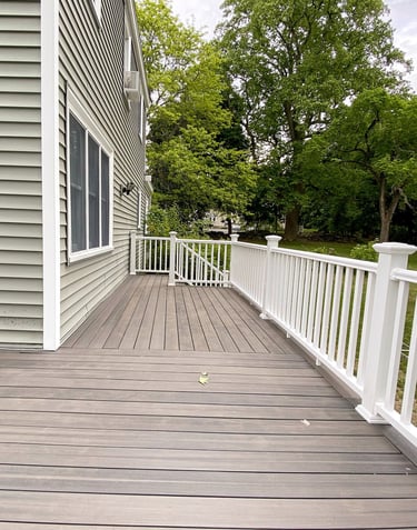 a custom pvc deck with a white hand rails