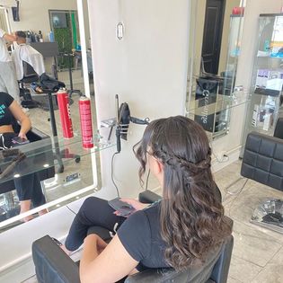 a woman sitting in a chair in a salon paul saoud