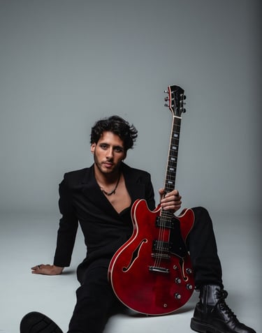 a guitar player in a suit and a guitar