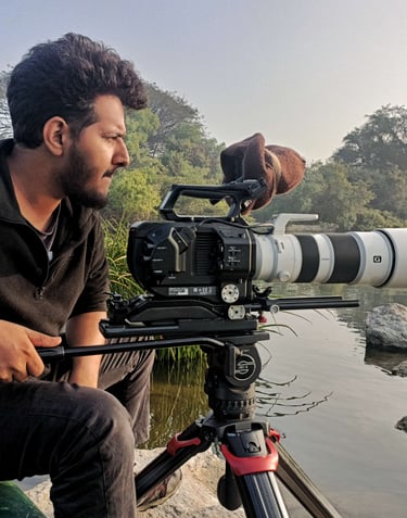 rakesh kote sitting on a bench with a camera and a camera