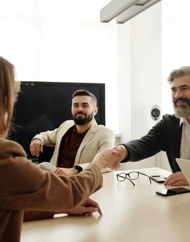 a man and woman shaking hands in a meeting room for mission