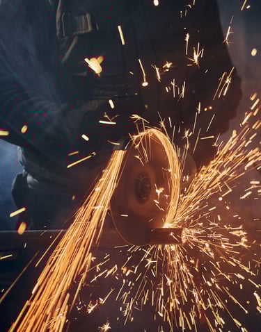 a man grinding a piece of metal with sparks