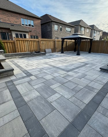 Backyard hardscaping project in the Greater Toronto Area featuring modern stone patio and garden