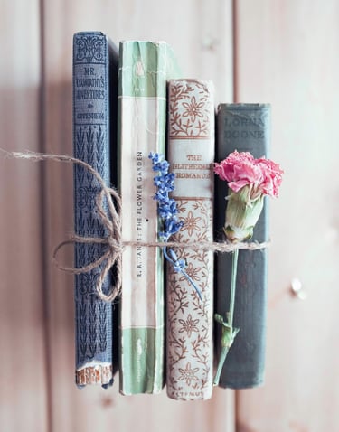 stack of ancient books with flowers - symbolizing learning & growth
