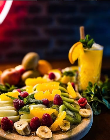 a plate of fruit and a glass of juice