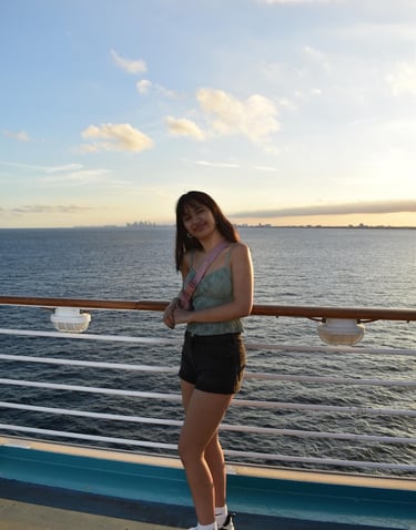 a woman standing on a deck deck of a cruise ship