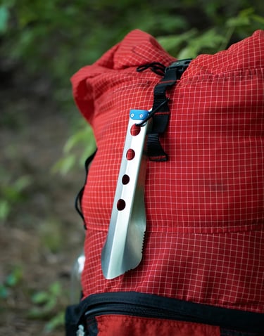 boglerco trowel clipped with carabiner on backpack