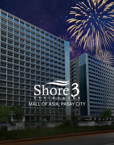 Shore 3 Residences condominium building in Mall of Asia, Pasay City with fireworks in the night sky.