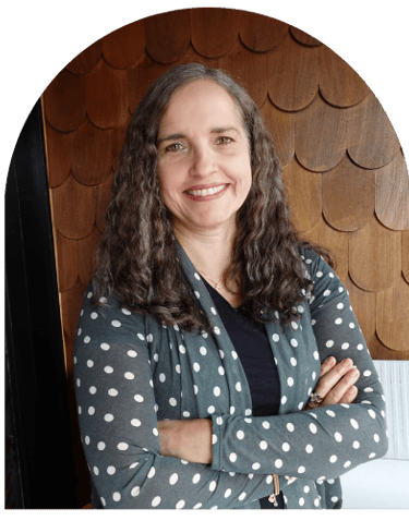 Paula Fontenelle, licensed professional counselor and therapist in Oregon, smiling with arms crossed