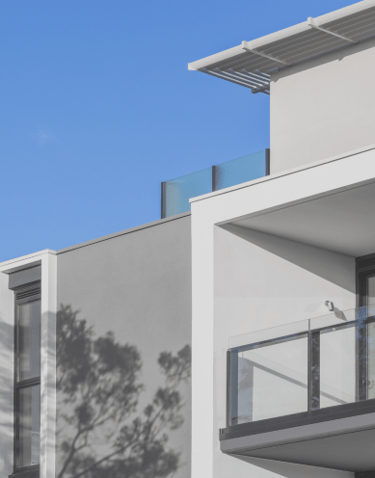 A grey building with a blue sky view.