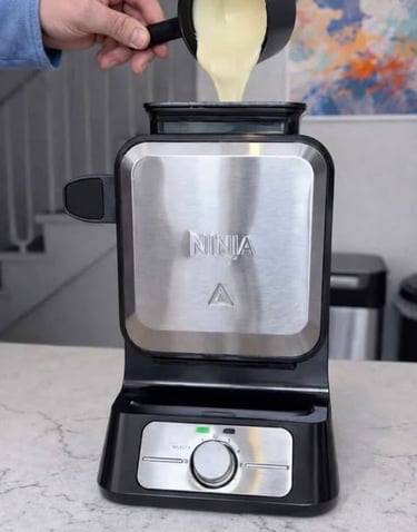 Standing waffle maker with batter being poured