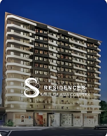 Modern high-rise exterior of S Residences luxury condominiums at the Mall of Asia Complex at night.