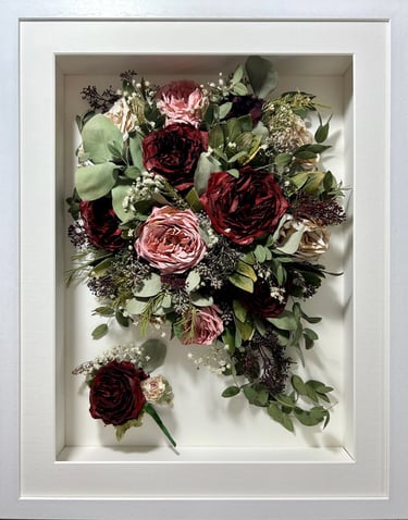 a trailing view preserved wedding bouquet with deep red and soft pinks in a frame