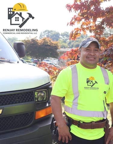 Jay Bravo, founder of Renjay Remodeling, standing by company vehicle in Connecticut
