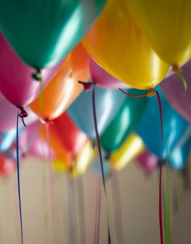 a bunch of colorful balloons floating in the air