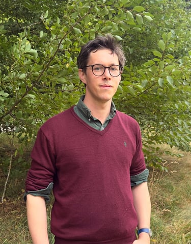 Tyler Hatwell, Psychotherapist & trainer, stood outside on a background of nature