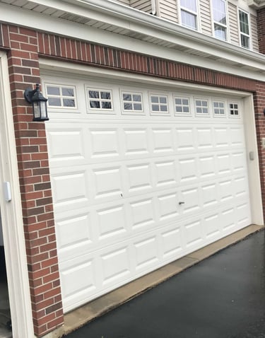 a car parked in front of a garage door