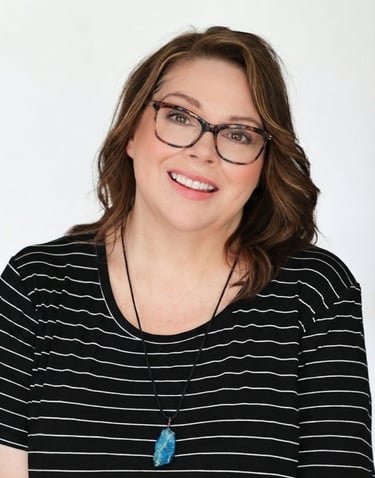 a woman with glasses and a necklace on her neck