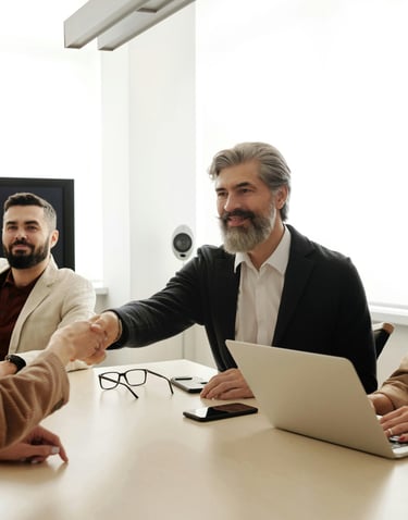 a man and woman shaking hands in a meeting room for mission