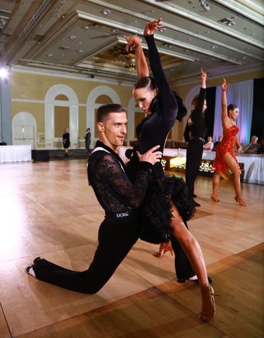 a man surprised  and holding a women in split postion