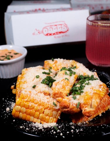 a plate of food with a slice of corn on it