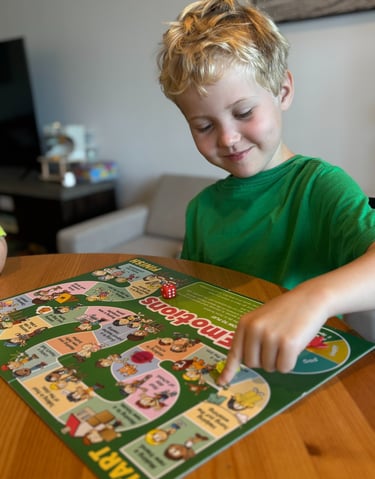 a boy playing a board game with a board game