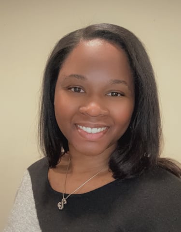 Professional headshot of Rashaye Harris, Operations Specialist smiling and w