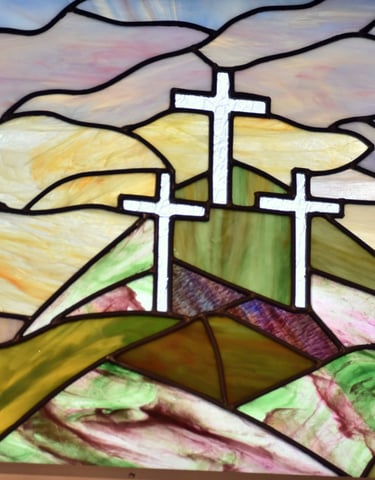 stained glass image of 3 crosses 