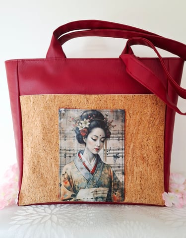 a woman's handbag with a picture of a woman in a kimono
