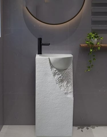 a bathroom with a sink and a plant in the background