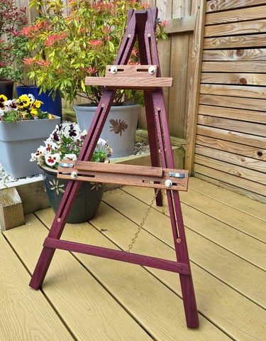 an artists easel on decking in a garden
