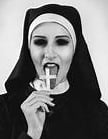 black and white photo of nun licking a crucifix 