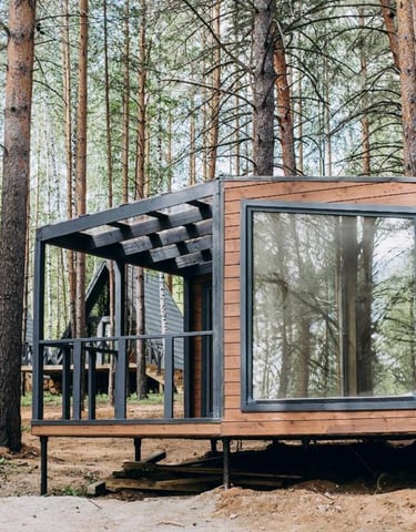 a tiny cabin in the woods with a bicycle