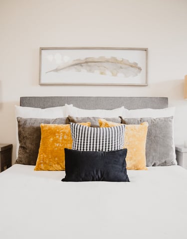 a bed with pillows and pillows on top of a bed
