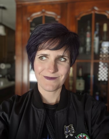 A picture of Kay, a White person wearing a black sport coat and shirt