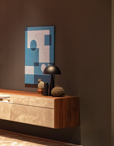a modern console table with a lamp and a painting