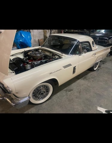 a car with a hood up being repaired