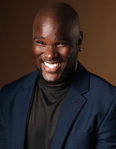 Smilling Bald Headshot Of Melvin Dain 