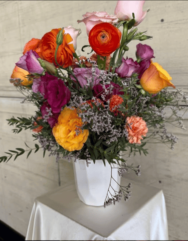 a vase with flowers in a vase on a table