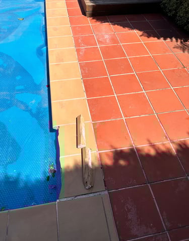 a pool with a blue pool and a deck
