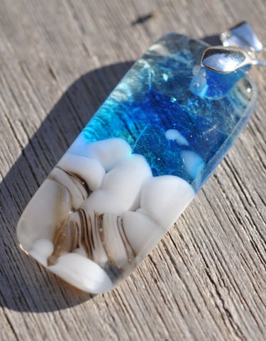 a blue and white glass pendant